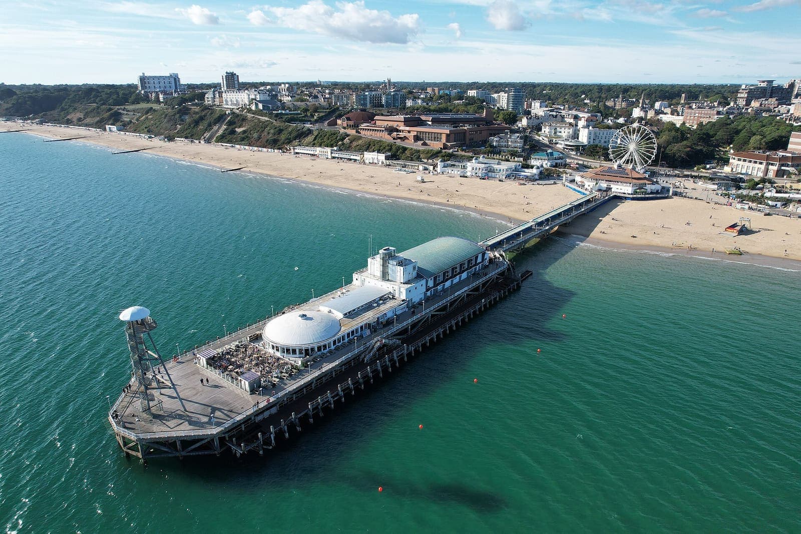 Aerial view of Bournemouth Pier and the beach stretching east below the cliffs